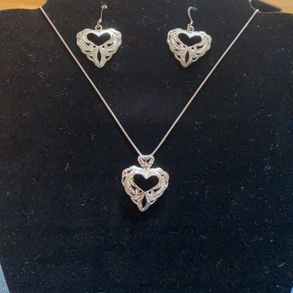 A sterling silver set of earrings and necklace